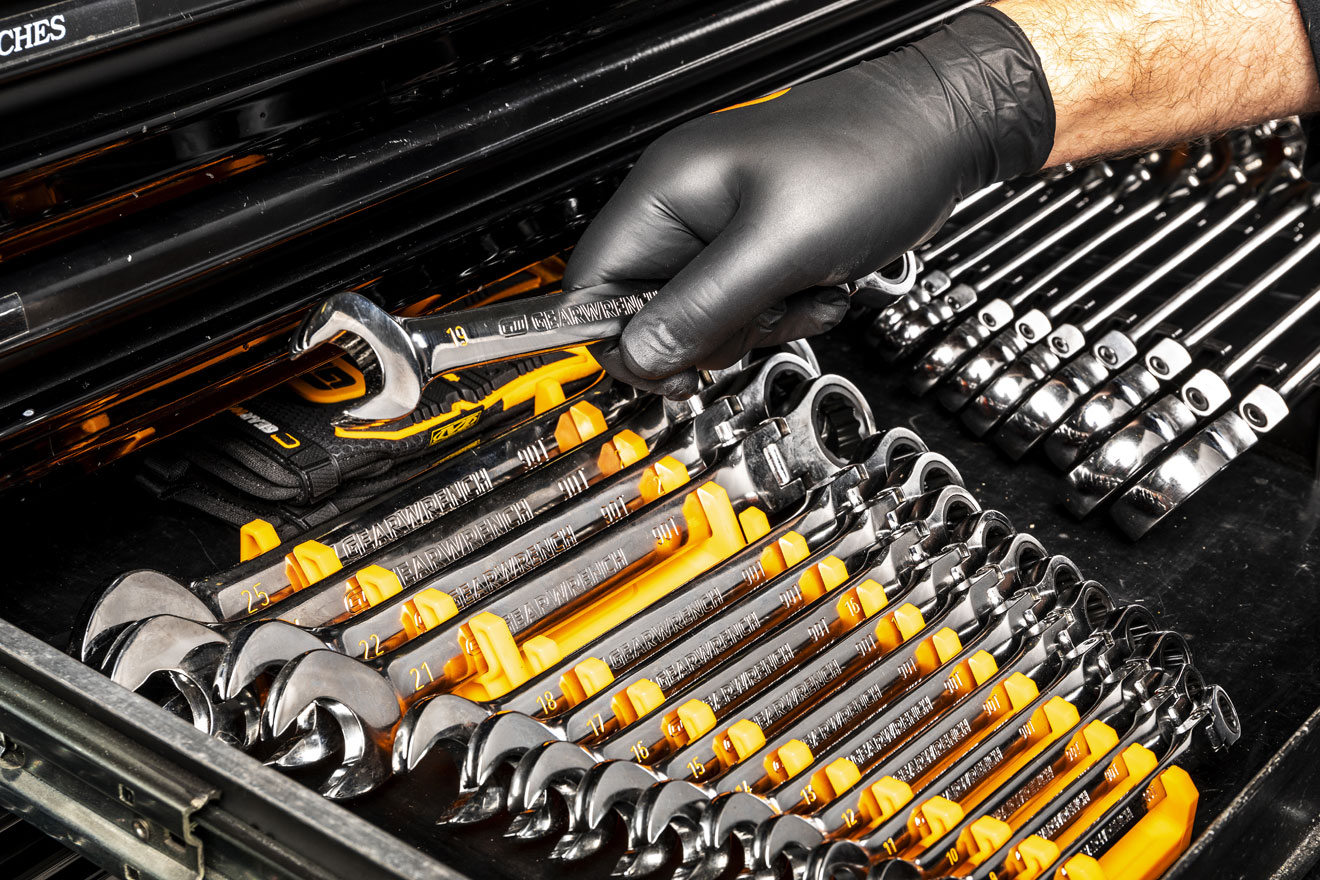 a photo of a worker selecting a wrench from a Gearwrench set