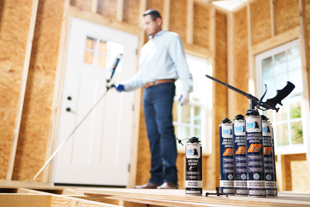 a photo of a worker applying Seal Spray Foam Sub-Floor & Construction Adhesive